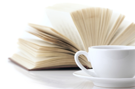 shutterstock_77718817 White cup of coffee and open book on white background
